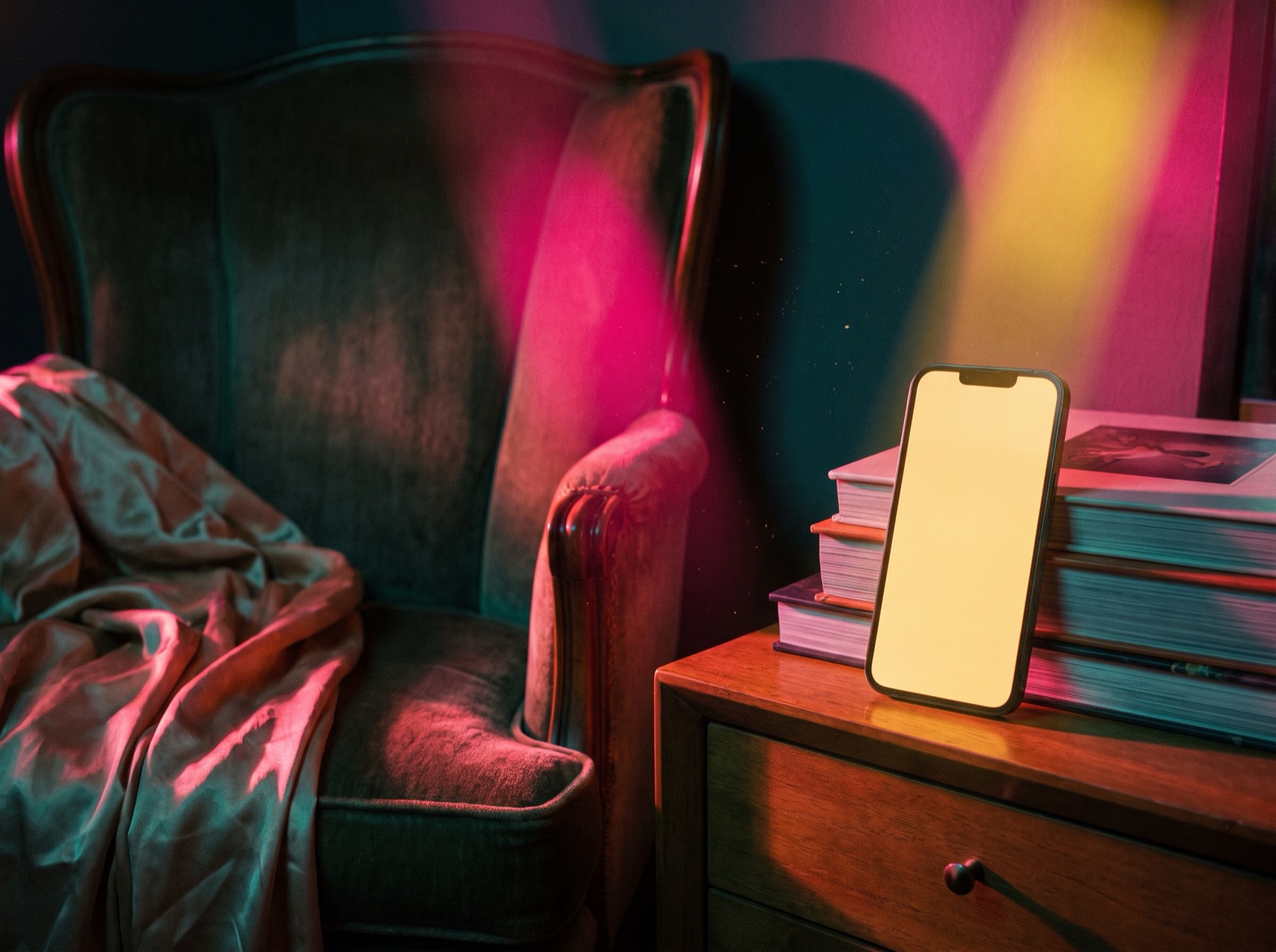 A glowing phone lighting an empty chair in a dark room